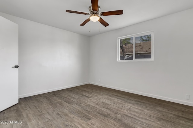 empty room featuring ceiling fan, baseboards, and wood finished floors