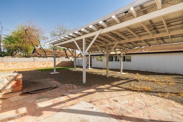 view of patio / terrace featuring a carport and fence