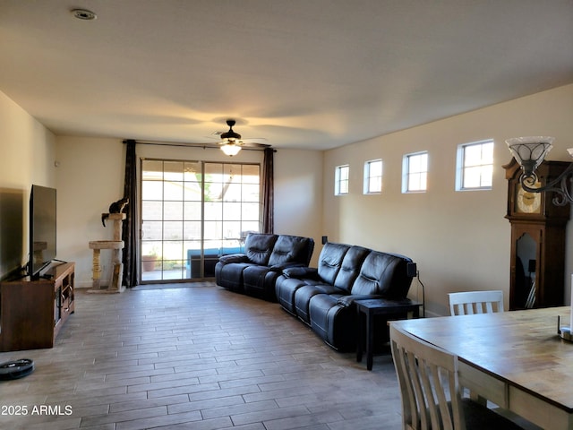 living room with a ceiling fan and wood finished floors