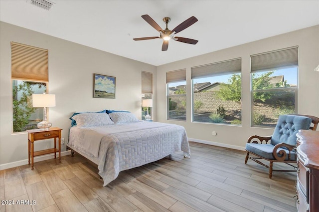 bedroom with ceiling fan and light hardwood / wood-style floors