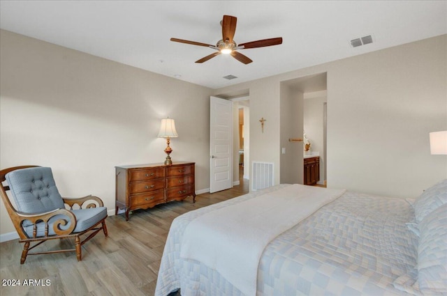 bedroom featuring ceiling fan, light wood-type flooring, and ensuite bathroom