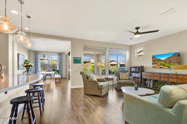 living room with hardwood / wood-style flooring and ceiling fan