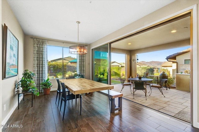 dining area featuring a mountain view, a chandelier, and hardwood / wood-style flooring