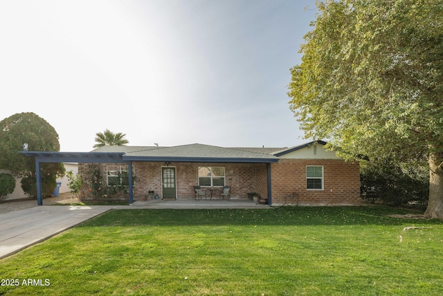 view of front of home with a front yard and a patio area