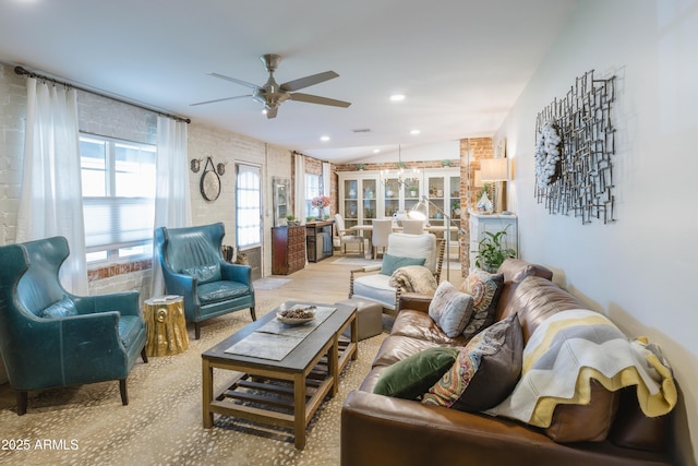 living room with ceiling fan and vaulted ceiling