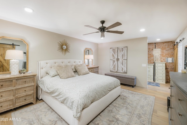 bedroom with ceiling fan and light wood-type flooring