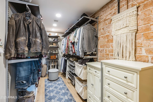 spacious closet featuring light wood-type flooring