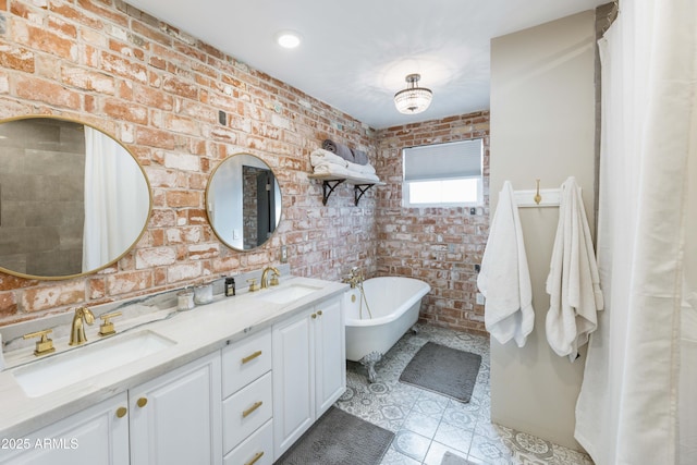 bathroom featuring brick wall, a bath, tile patterned flooring, and vanity