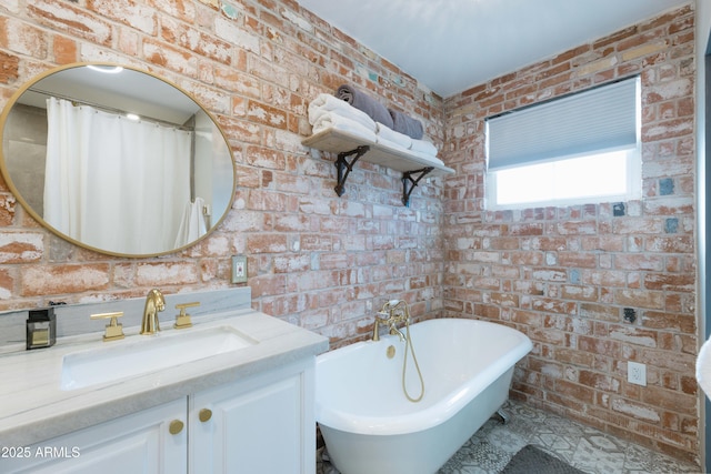 bathroom with vanity, a tub, and brick wall