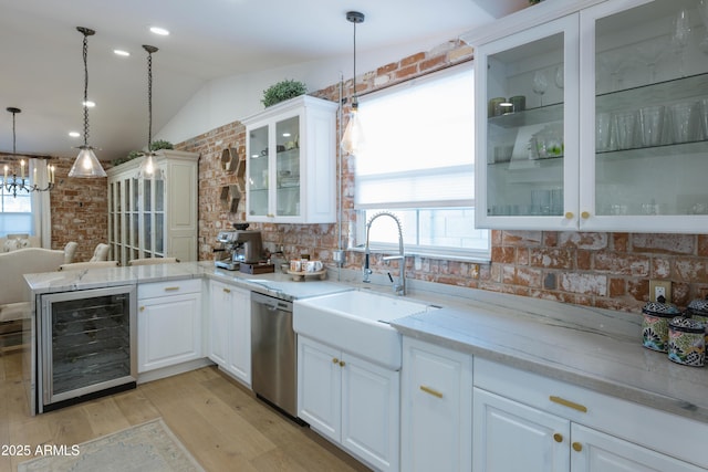 kitchen with pendant lighting, stainless steel dishwasher, beverage cooler, and white cabinets