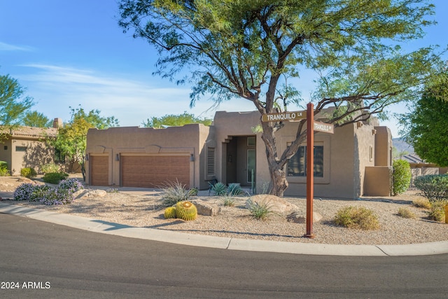 adobe home featuring a garage