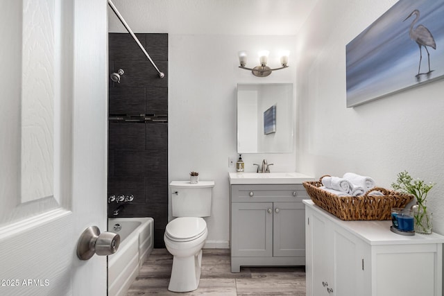 full bathroom featuring shower / bath combination, toilet, vanity, and wood finished floors