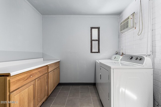 laundry room featuring baseboards, a wall mounted AC, cabinet space, separate washer and dryer, and tile patterned floors