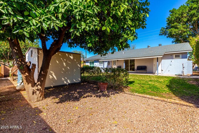 view of front of house with an outbuilding and a patio