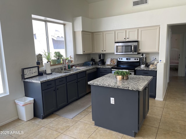 1314 S Larkspur St, Gilbert, AZ 85296 - kitchen featuring visible vents, light tile patterned flooring, light stone countertops, a center island, and stainless steel appliances