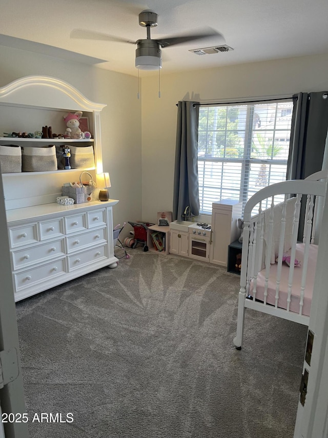 1314 S Larkspur St, Gilbert, AZ 85296 - carpeted bedroom featuring a ceiling fan, visible vents, and a crib