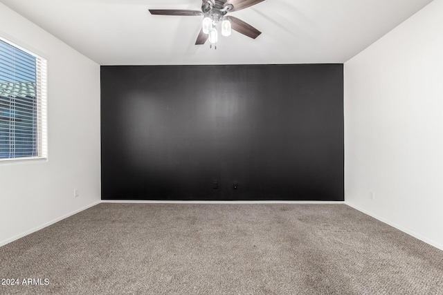 spare room with carpet and ceiling fan