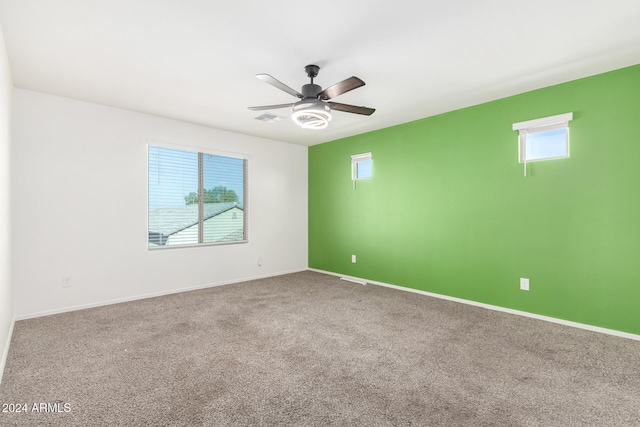 carpeted spare room with ceiling fan