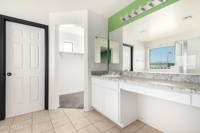 bathroom featuring tile patterned flooring and vanity