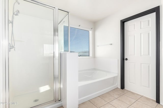 bathroom featuring tile patterned flooring and shower with separate bathtub