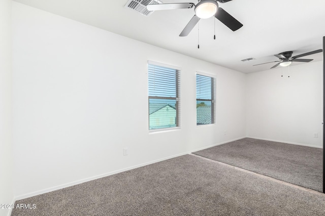 empty room with ceiling fan and carpet floors