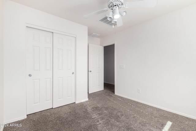 unfurnished bedroom featuring a closet, dark carpet, and ceiling fan