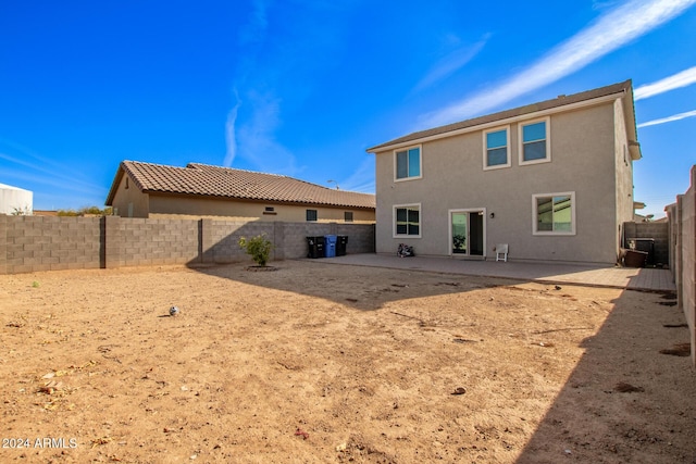 rear view of house featuring a patio