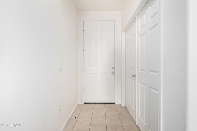 corridor featuring light tile patterned floors