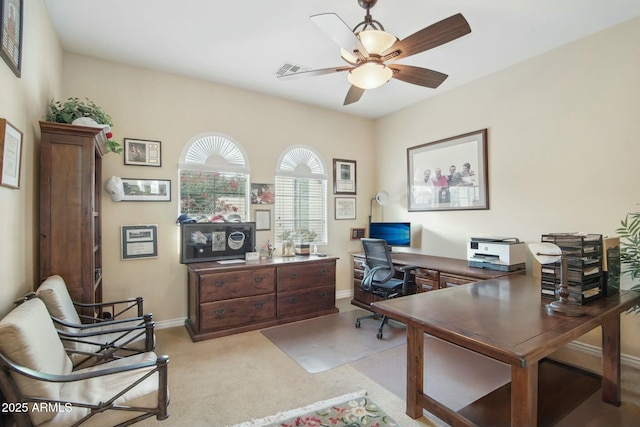 home office featuring ceiling fan and light carpet