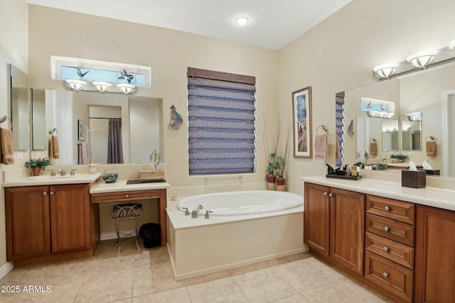 bathroom featuring tile patterned floors, a bathing tub, and vanity