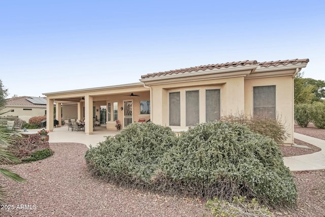 back of house featuring ceiling fan and a patio area