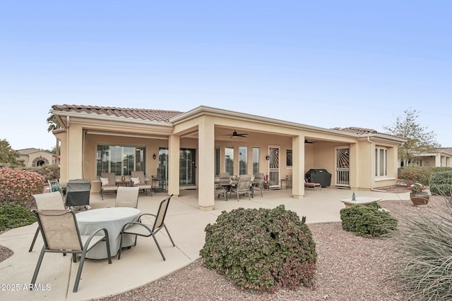 back of house featuring ceiling fan and a patio area