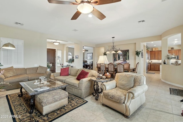 living room with light tile patterned floors and ceiling fan