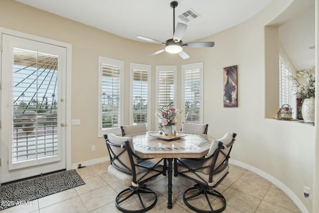 tiled dining space featuring ceiling fan