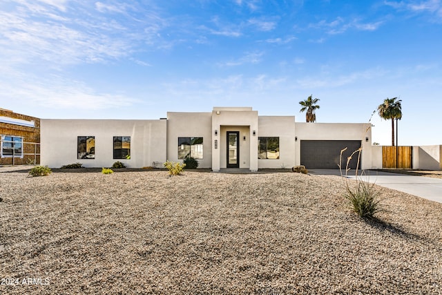 pueblo-style home with a garage