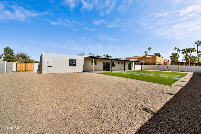 rear view of house with a yard