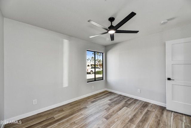 spare room with ceiling fan and light hardwood / wood-style floors