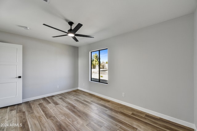 empty room with light wood-type flooring and ceiling fan