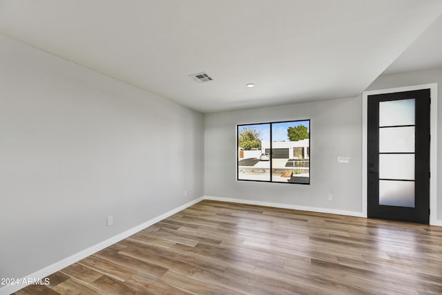 spare room with light hardwood / wood-style flooring