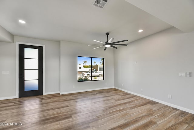 empty room with light hardwood / wood-style flooring and ceiling fan