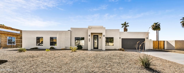 pueblo-style house featuring a garage