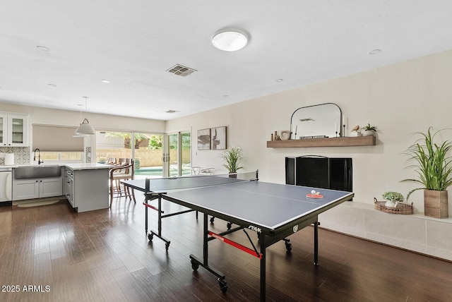 5912 E Wethersfield Rd, Scottsdale, AZ 85254 - game room with dark wood-style floors and a fireplace