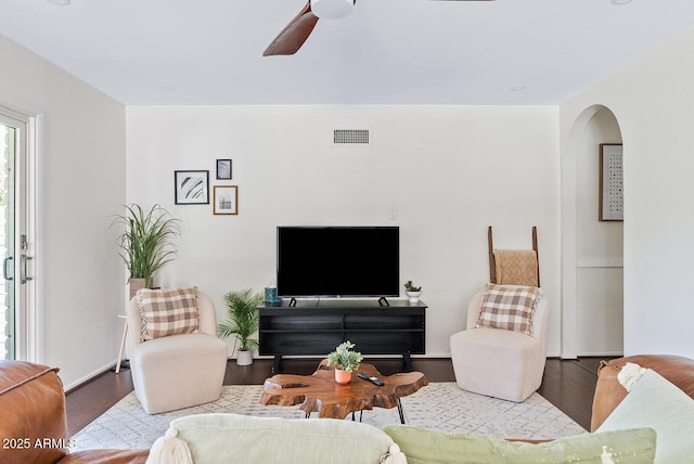 5912 E Wethersfield Rd, Scottsdale, AZ 85254 - living room featuring wood finished floors, a ceiling fan, and arched walkways