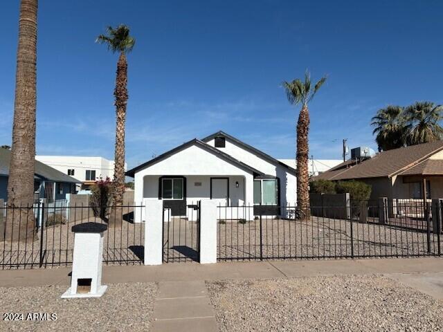 2114 W Washington St, Phoenix, AZ 85009 - view of front of house with a fenced front yard and stucco siding