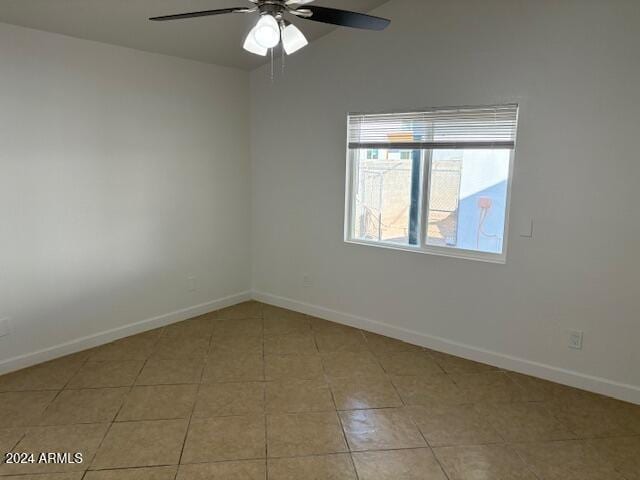 spare room with light tile patterned floors and ceiling fan