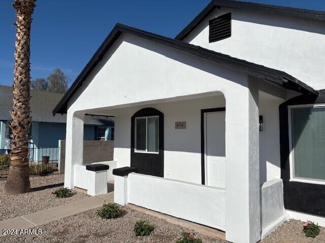 view of side of home with a porch