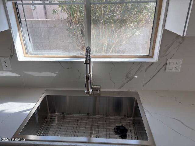 interior details with white cabinets and sink