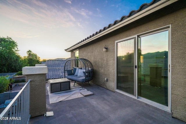 patio terrace at dusk with a balcony