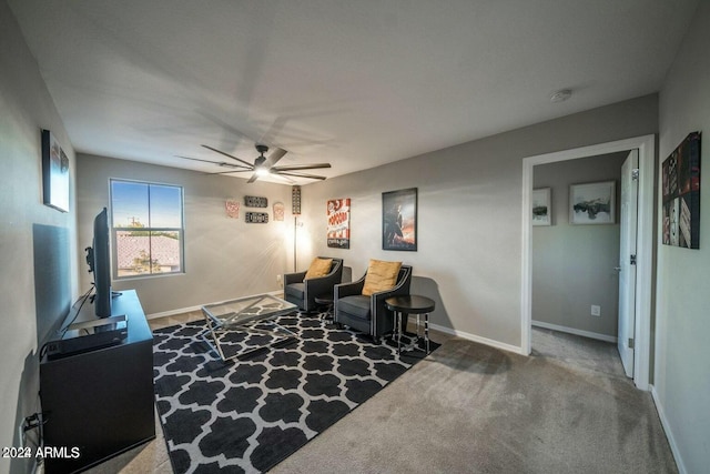 sitting room featuring carpet and ceiling fan