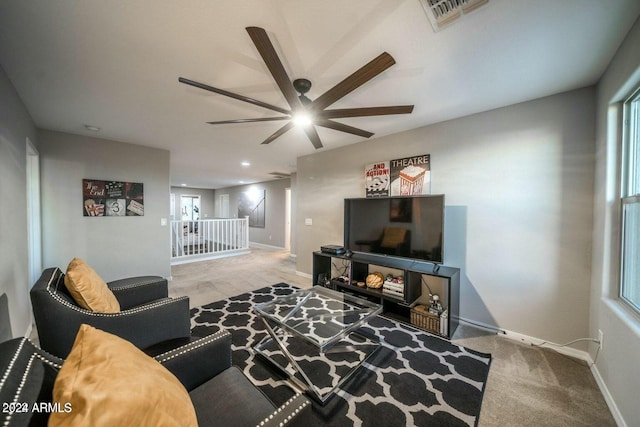 carpeted living room featuring ceiling fan